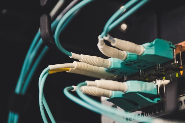 Fiber optic cables plugged in showing dedicated fiber internet connection