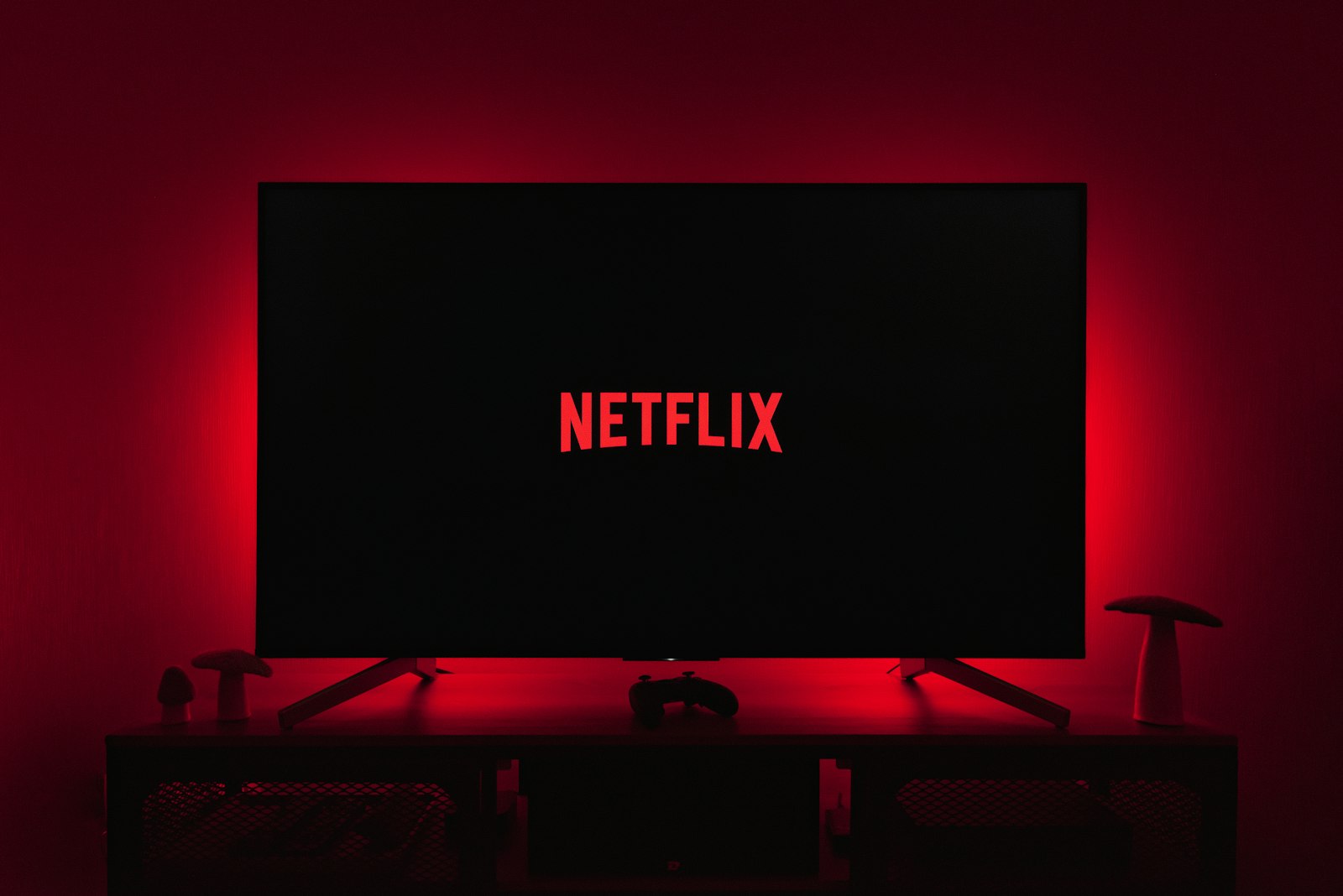 Netflix logo glowing on TV in dark room
