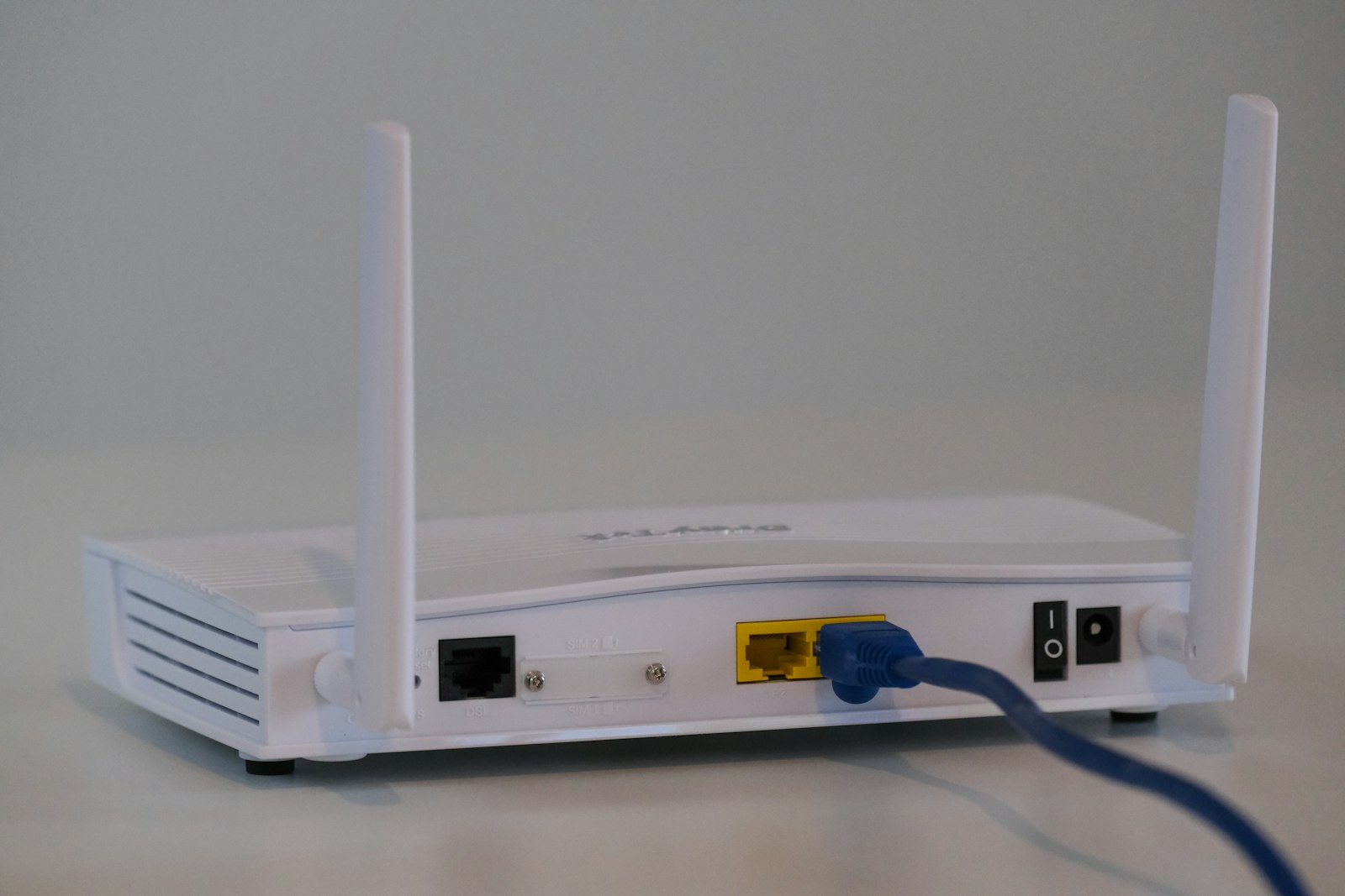 Modern white WiFi router on table
